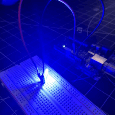 Activating an LED on the breadboard connected to the Arduino.